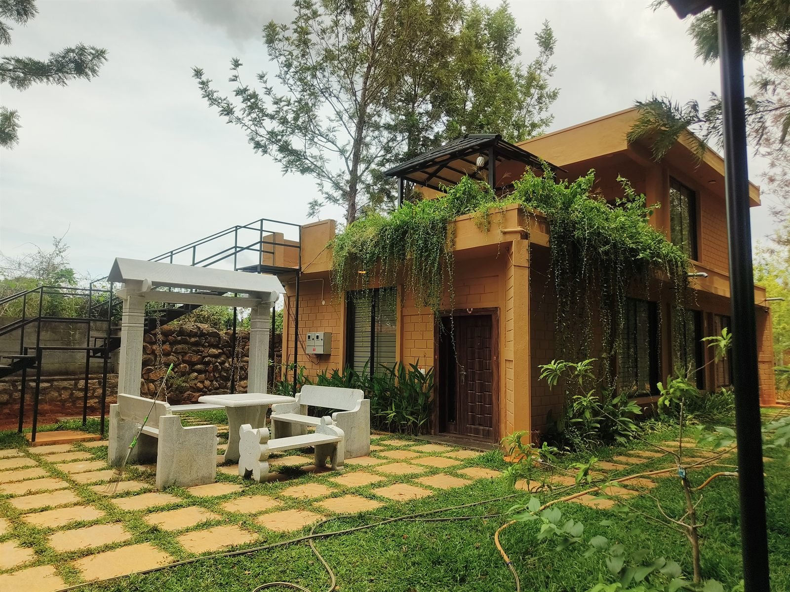 Stone courtyard with seating and climbing vines
